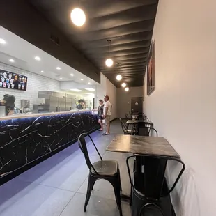 Seating area inside adjacent to the choices of ice cream flavors