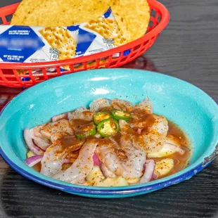 a bowl of food and a basket of chips