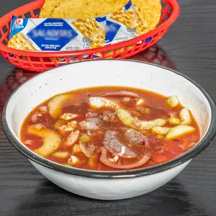 a bowl of soup and a basket of chips