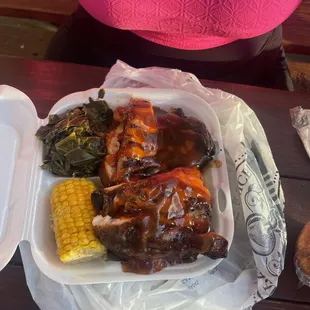 BBQ chicken plate, corn on the cobb and Collard Greens