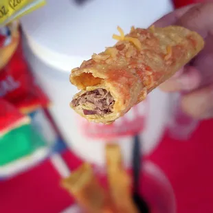 a hand holding a piece of food