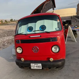 the front end of a red vw bus