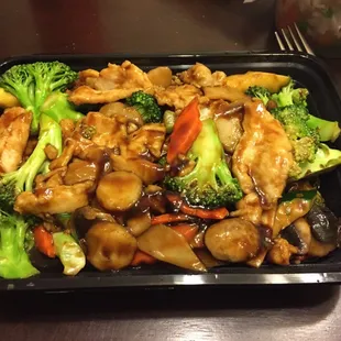 Large portion of the chicken with broccoli and mushrooms. Some carrot, too.