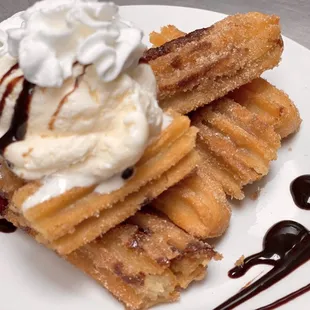 Stuffed cinnamon churros topped with vanilla ice cream
