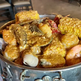 Create your own boil with half pound each of, Manila clams, green mussels, crayfish, shrimp, scallops, sausage, potato and corn.