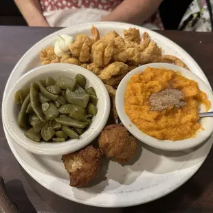 Lunch portion of the fried shrimp with green beans, mashed sweet potato and hush puppies.