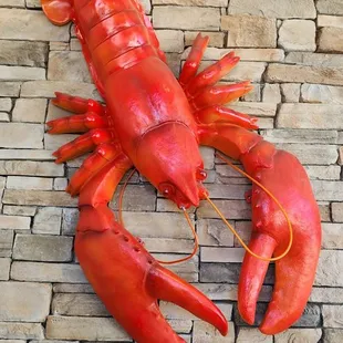 a lobster on a brick floor