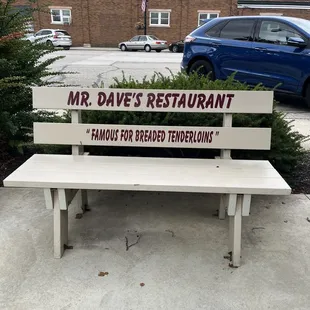 a bench with a sign on it