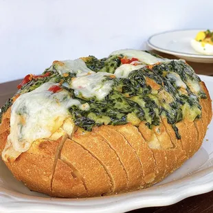 Spinach Dip Hot Bread w/ french bread, calabrian chili, mozzarella ($12)