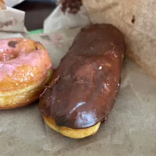 two donuts with chocolate and pink glaze