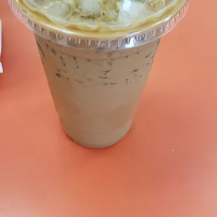 a cup of iced coffee on a table