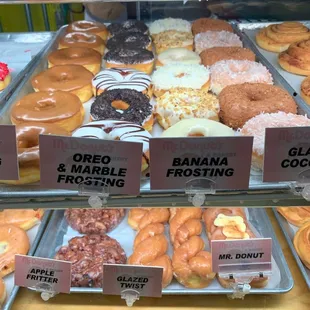 Assorted glazed, apple fritters and twist donuts