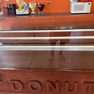 Empty donut shelves at 12:30 pm.