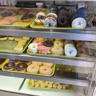 a variety of donuts in a display case