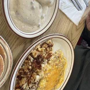 Meat lovers omelette with biscuits and gravy as the side.