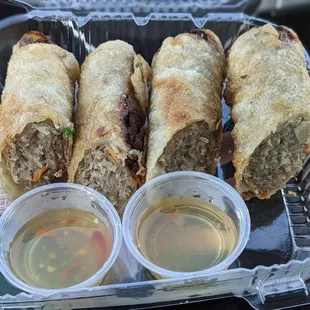 Two jumbo pork egg rolls with dipping sauces
