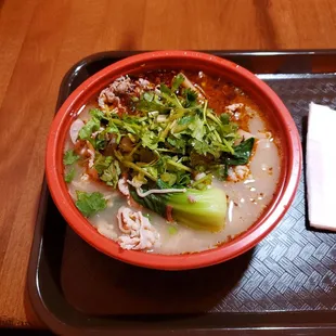 a bowl of soup on a tray