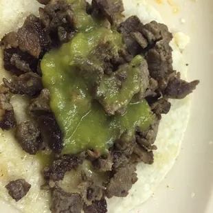  a beef and guacamole on a tortilla
