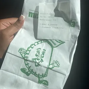 a person holding a paper bag