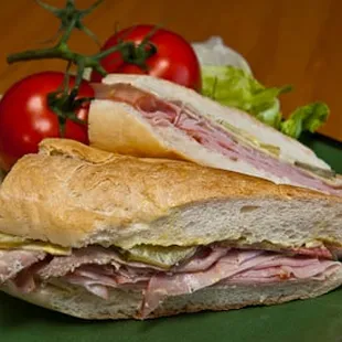 a ham sandwich with lettuce and tomatoes