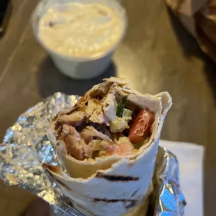 a hand holding a burrito