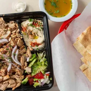 a tray of chicken salad and pita chips