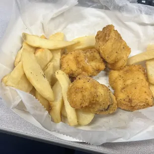 a basket of fried fish and french fries