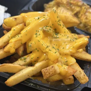 Golden crispy fries with cheese and garlic lemon wings