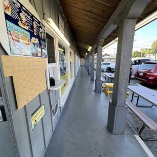 a sidewalk with benches and tables