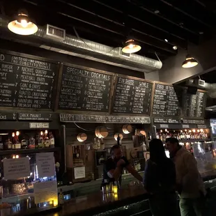 Bartender and patron no masks/masks down. Talking and jolting for over 5 minutes while others wait.