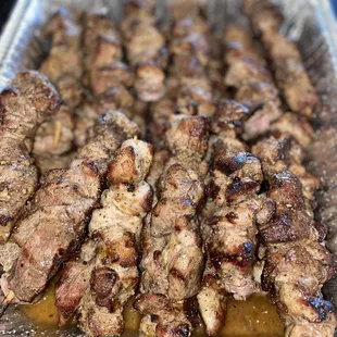 a tray of meat skewers