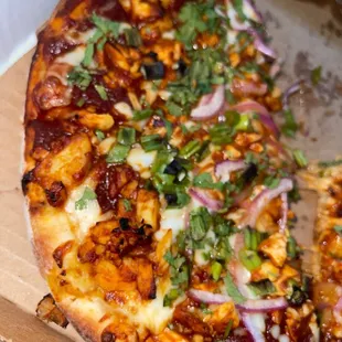 a half eaten pizza in a box