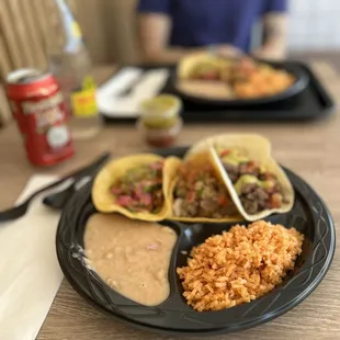 3 taco plates with rice and beans
