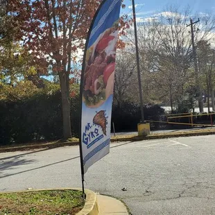 a flag on the corner of a parking lot