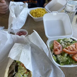 Traditional Gyro and Greek salad in foreground. Rice and Italian gyro in the background.