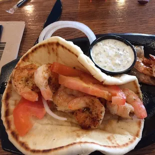 Shrimp souvlaki (lunch) with tzatsiki sauce.