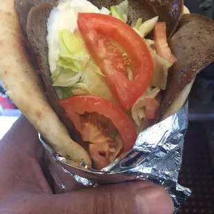 a hand holding a sandwich