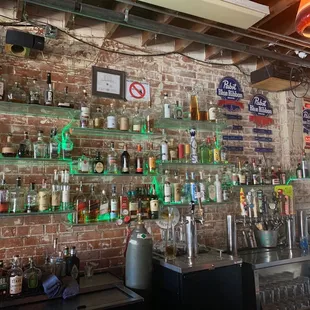 a brick wall with a lot of bottles on it