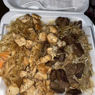 a styrofoam container filled with meat and vegetables