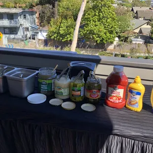a table with condiments and condiments