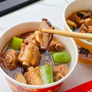 two bowls of soup with chopsticks