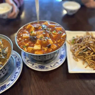 three bowls of food on a table