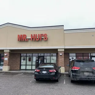 two cars parked in front of the store