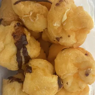 Cream filled chocolate glazed puffs