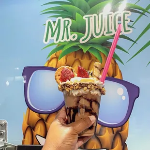 a pineapple with ice cream and strawberries