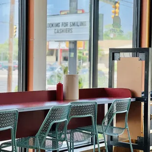 a table and chairs in front of a window