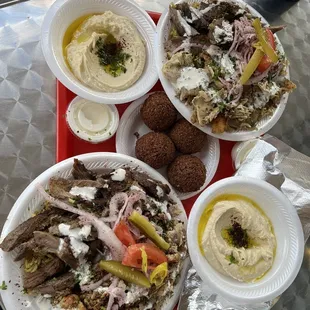 Shawarma plate with half chicken and half beef, side of hummus and extra falafels