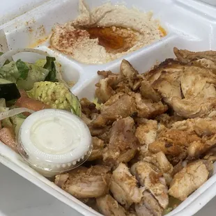Chicken shawarma plate - lots of meat atop a bed of rice.  Tasty hummus and salad.  To go plate.