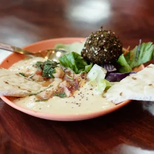a bowl of soup and pita chips