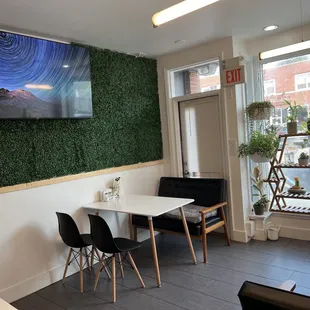 a dining room with a large picture on the wall